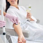 Smiling female patient undergoing intravenous vitamin therapy